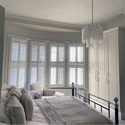 Tier on tier window shutters installed in a bay window in Liverpool.